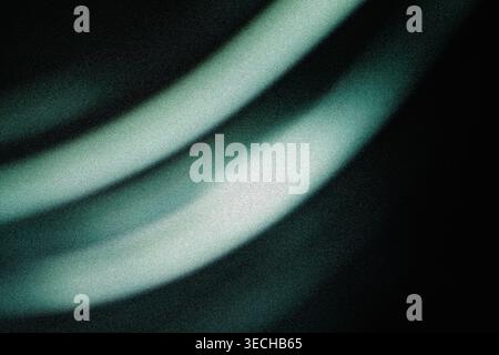 Abstract flowing light waves in soft green and white with dark noisy backdrop Stock Photo