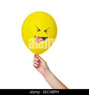 Hand Holding Yellow Balloon with Funny Face Isolated on White Background Stock Photo
