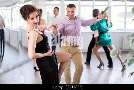 Man and woman practicing swing dance in dancing studio Stock Photo