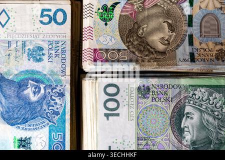 Stacks of Polish banknotes in denominations of 50, 100, and 500 zloty are arranged in a layered view that highlights the structure Stock Photo