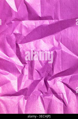 Crumpled purple paper creating an abstract background texture with sharp creases, folds, and natural wrinkles Stock Photo
