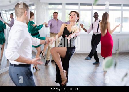 Man and woman practicing swing dance in dancing studio Stock Photo