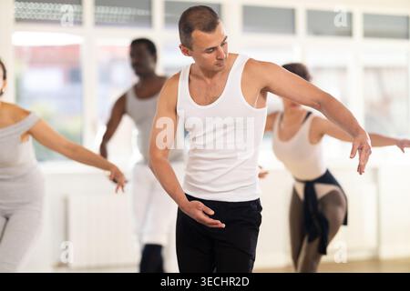 Ballet artist leading group rehearsal with amateur dancers Stock Photo
