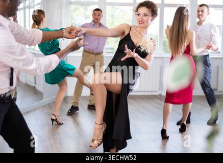 Man and woman practicing swing dance in dancing studio Stock Photo