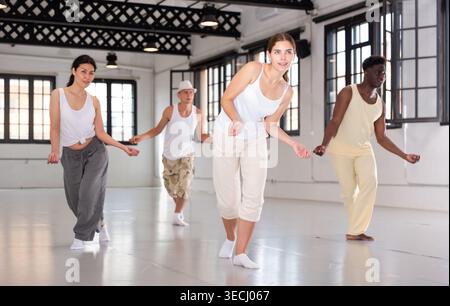 Four dancers exercising swing movements Stock Photo