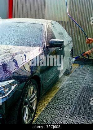 Car wash at a self-service car wash. Car wash concept Stock Photo