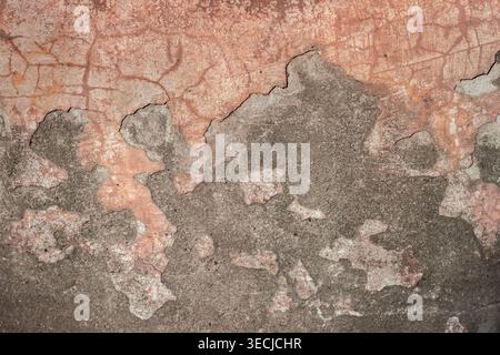Macro horizontal full frame background texture of red shabby concrete cement wall surface with deep cracks and peeling plaster layers Stock Photo
