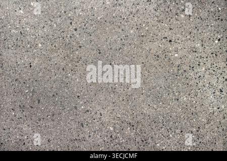 Macro horizontal full frame background texture of abstract grey asphalt road surface with fine grain pattern Stock Photo