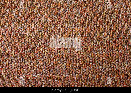 Macro horizontal full frame background texture of colorful melange knitted fabric pattern with warm brown orange and yellow rows Stock Photo