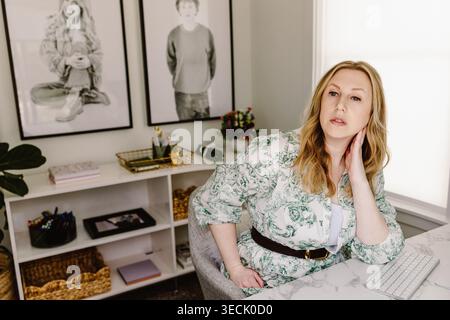 Confident woman working in stylish home office Stock Photo
