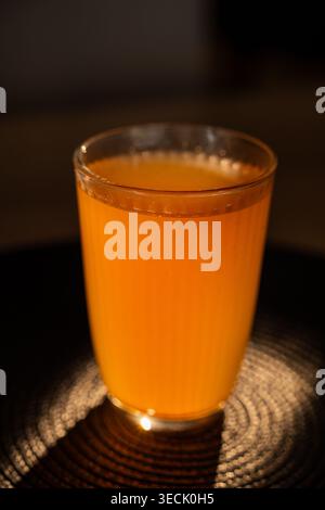 Fruit compote in glass on dark coaster and dark background Stock Photo