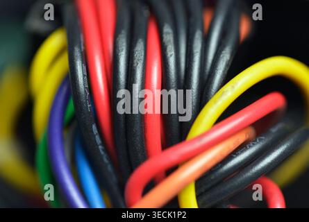 Multi coloured wires on the motherboard of a computer Stock Photo