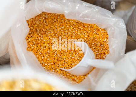 Large bag of dry corn for sale in grocery store Stock Photo