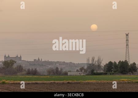 A tranquil scene of electricity infrastructure with power lines stretching across the horizon at sunset, blending nature and technology against a past Stock Photo