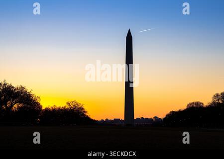 The Washington Monument in silhouette at sunset in Washington DC, backlit by the setting sun, famous obelisk memorial landmark in the American capital Stock Photo