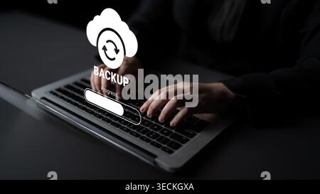 A close view of hands typing on a laptop with a cloud backup icon and a progress bar visible on the screen, encapsulating the essence of modern Stock Photo