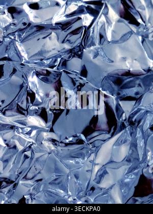 Shiny crumpled abstract silver foil close up background Stock Photo