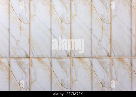 Elegant white marble tile texture featuring beautiful natural gold pattern creates calm background surface for interior design architecture decor and Stock Photo