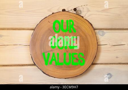 Our core values words symbol. Concept words Our core values on beautiful wooden circle. Beautiful wooden wall background. Business our core values mot Stock Photo