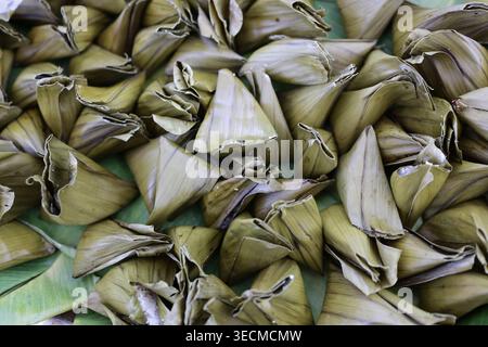 Traditional Southeast Asian steamed sweet cakes wrapped in banana leaves Stock Photo