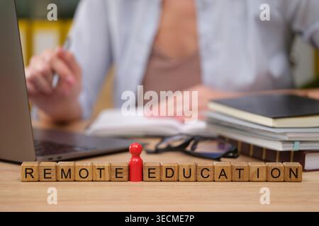 A focused student engages in remote education at a cozy desk, surrounded by books and a laptop. The scene embodies the evolving landscape of learning Stock Photo