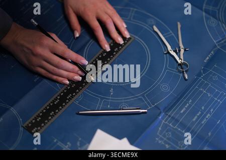 Professional draftsman creating precise architectural blueprints Stock Photo