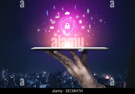 Digital Security Concept with Shield Icon and Data Symbols Floating Above a Person Hand in a Cityscape at Night Quark. Stock Photo