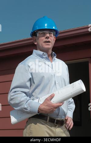Engineering contactor supervisor with blueprints plans, USA Stock Photo