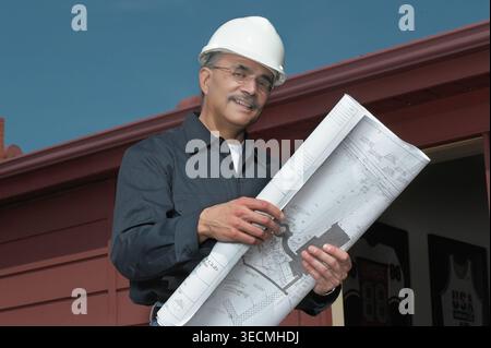 Engineering contactor supervisor with blueprints plans, USA Stock Photo