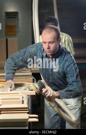 Woodworker sanding cabinet frame, Tennessee, USA Stock Photo