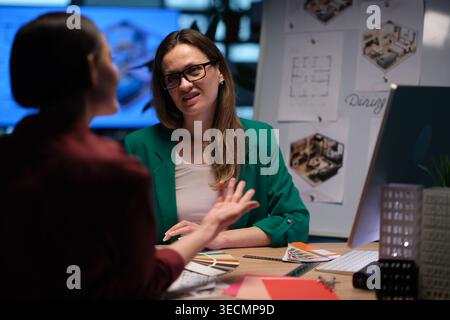 Engaging interior design discussion between two professionals in a creative workspace Stock Photo