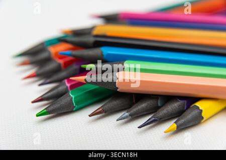 Pencils in various colors are placed on a flat surface ready for use in art projects and creative tasks. Stock Photo