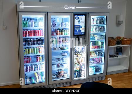 Convini self service fridge displays colorful drinks and snacks in an office. Clean lines and cool lighting enhance product appeal. Nynashamn, Stockho Stock Photo