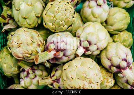 Fresh artichokes displayed on a market stall. Madrid, Comunidad de Madrid, Spain, Europe Stock Photo