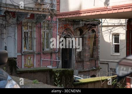 Istanbul, Turkey - April 1, 2026: Old residential buildings in Balat with worn facades, arched windows, metal bars with layered structures Stock Photo