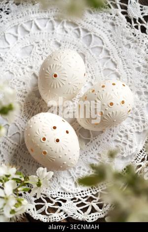 Three white Easter eggs decorated with wax, top view Stock Photo
