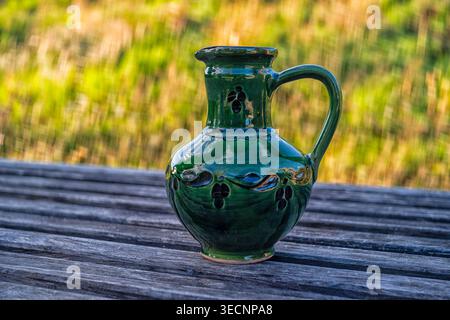 An old jug on a wooden table object, publication Stock Photo