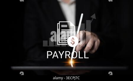 A professional hand using a stylus on a tablet illustrates payroll concepts with graphic elements showing financial growth and analysis in a modern Stock Photo
