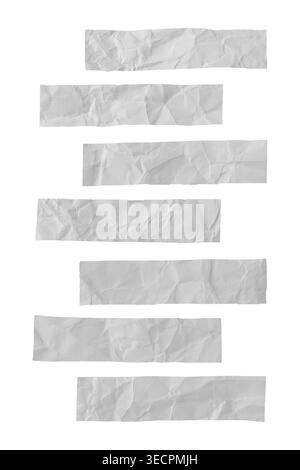 Crumpled white paper strips showing wrinkled surfaces and rough edges, creating a versatile abstract texture. Isolated Stock Photo
