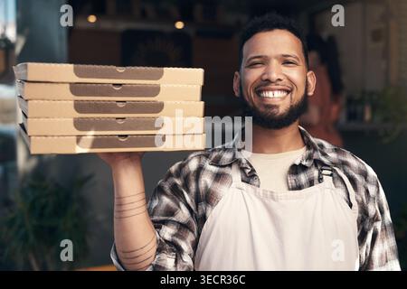 Smile, man and boxes with pizza at restaurant for food order, dish preparation and delivery. Portrait, male chef and Italian recipe for meal takeaway Stock Photo