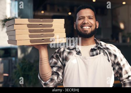 Portrait, man and boxes with pizza at restaurant for food order, dish preparation and delivery. Male person, chef and Italian recipe for meal takeaway Stock Photo