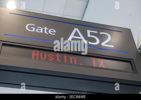 Close-up of an airport gate sign showing Gate A52 and an electronic destination display for Austin, Texas. Stock Photo