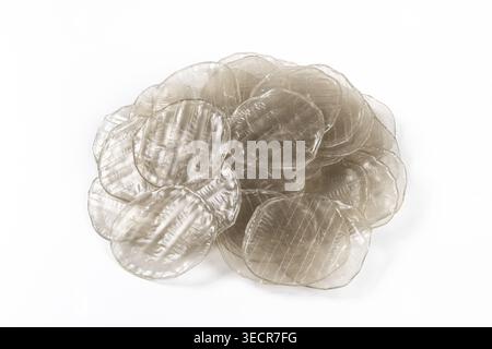 Clear plastic discs creating an abstract textural formation against white background Stock Photo