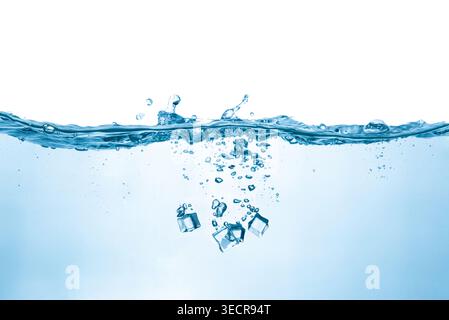 Ice cubes dropping into clear water creating bubbles and splashes Stock Photo