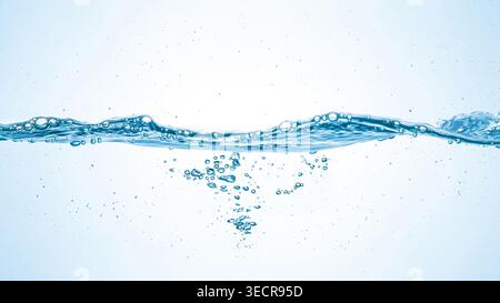 Blue water creating wave and small bubbles against a white background Stock Photo