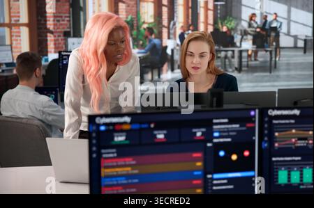 Cybersecurity Engineer Carefully Monitors Network Dashboard To Prevent Breaches. Stock Photo