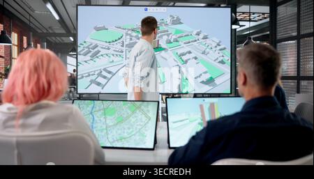 GIS Engineer Presenting Digital Twin Maps To Team For Property Planning. Stock Photo