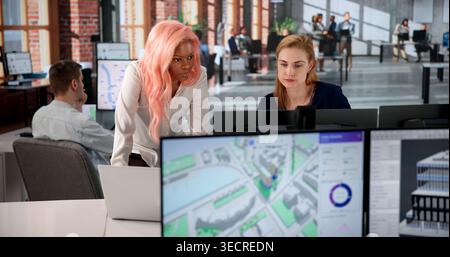 Urban Land Mapping Engineer Studies 3D City Models Using Computer Software. Stock Photo