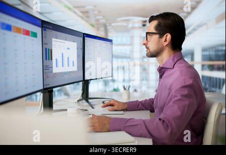 Sales Manager Studies Lead Scoring Dashboard On PC To Boost Pipeline. Stock Photo