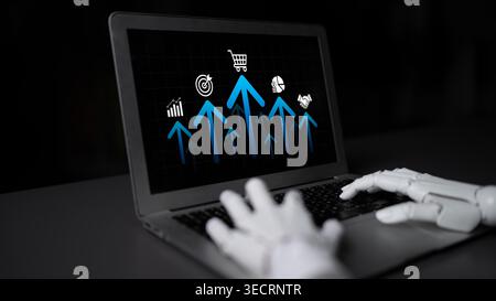 A robotic hand interacts with a laptop displaying growth graphs and e-commerce icons, reflecting advancements in technology and digital business Stock Photo